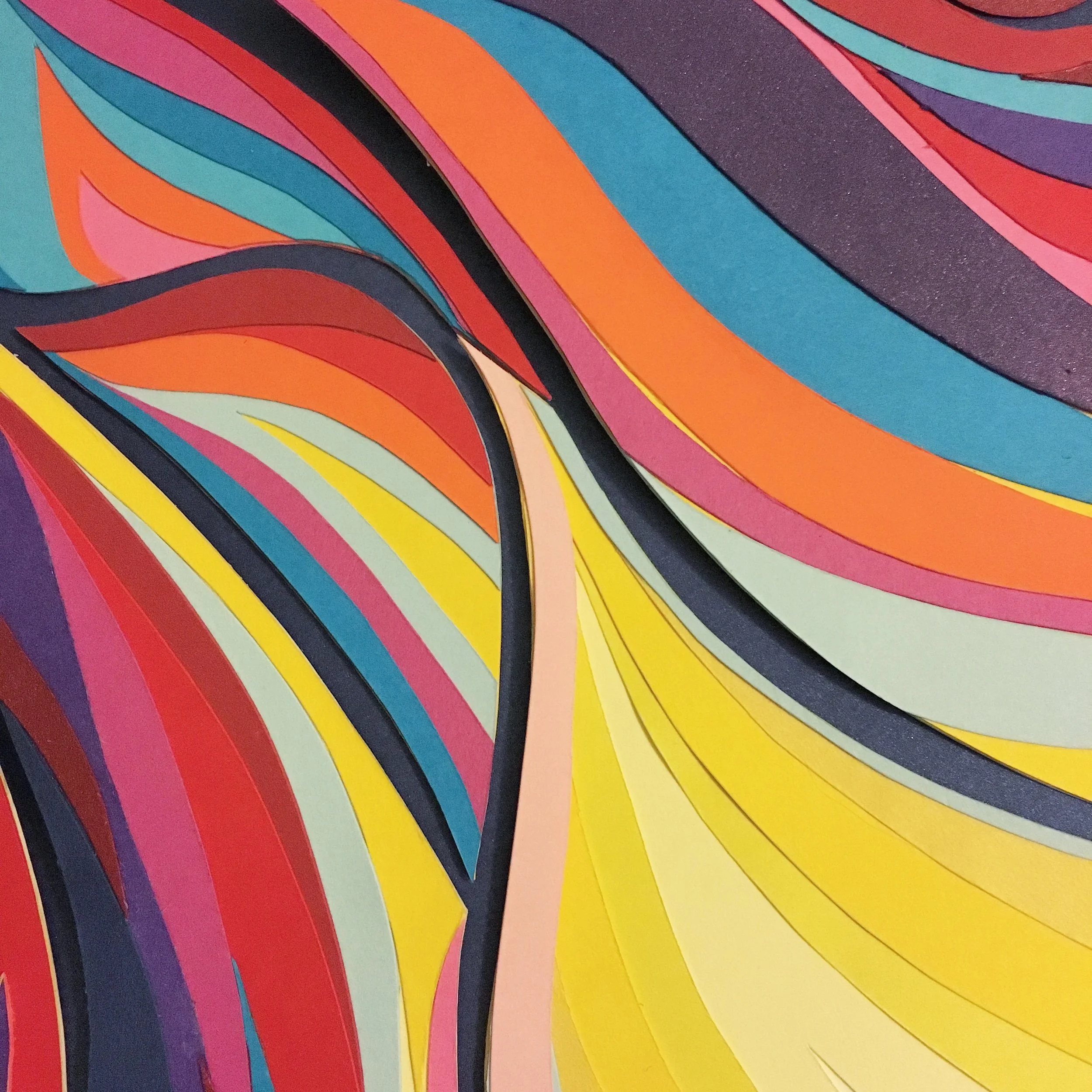 Colorful abstract paper art with swirling layers in shades of pink, orange, yellow, blue, purple, and black.