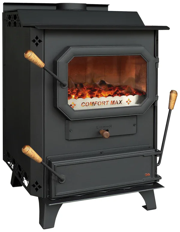 A black wood stove with a glass door showing a fire inside, labeled 'Comfort Max,' with wooden-handled tools on the sides.