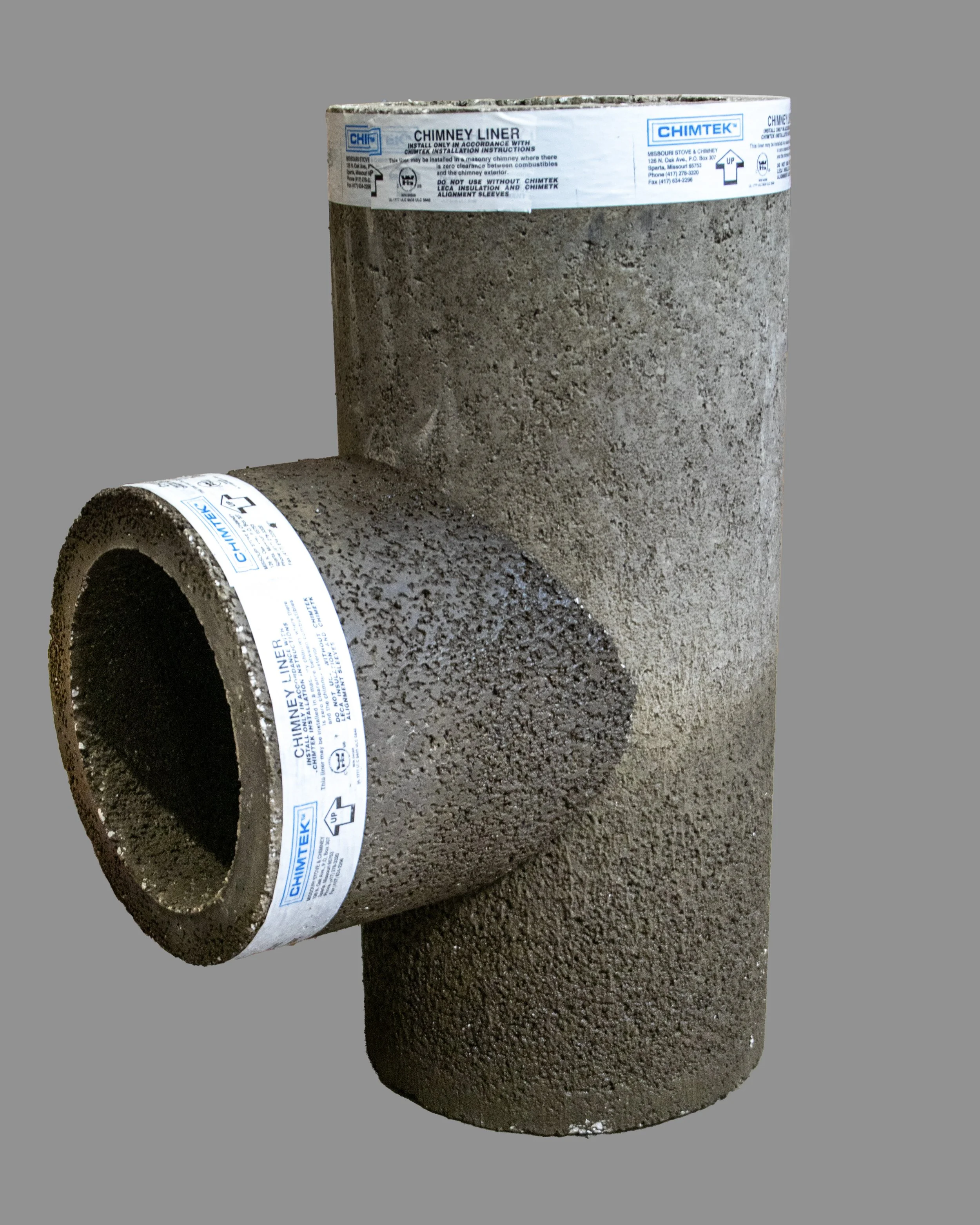 Two pieces of chimney liner pipe with textured, dark brown surface and labels, positioned against a plain gray background.