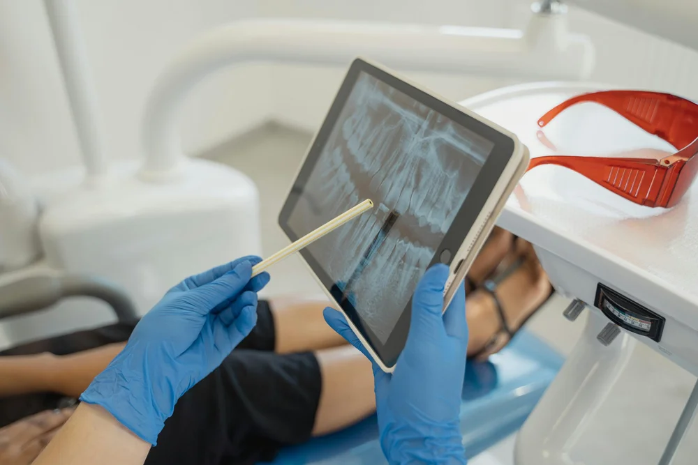Dentist reviewing an X-ray on a tablet