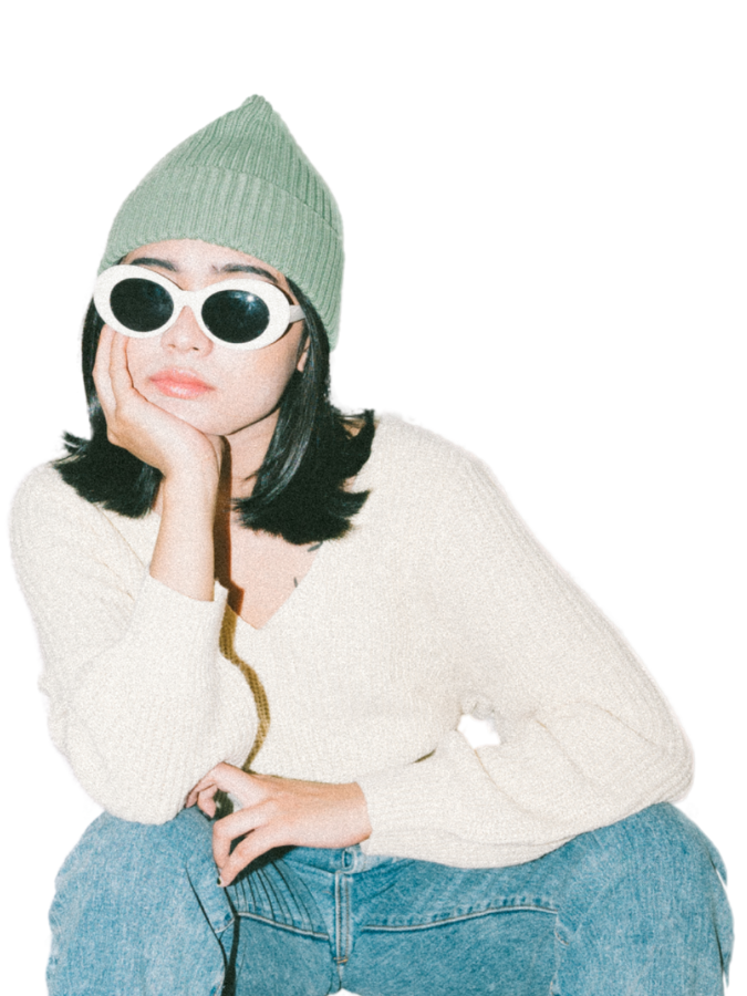 Woman in beanie and sunglasses resting hand on chin