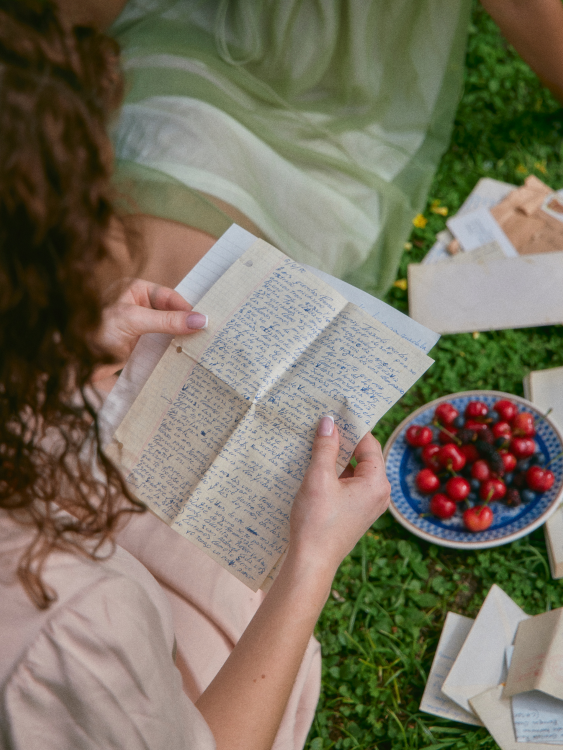 handwritten letter being held by two hands