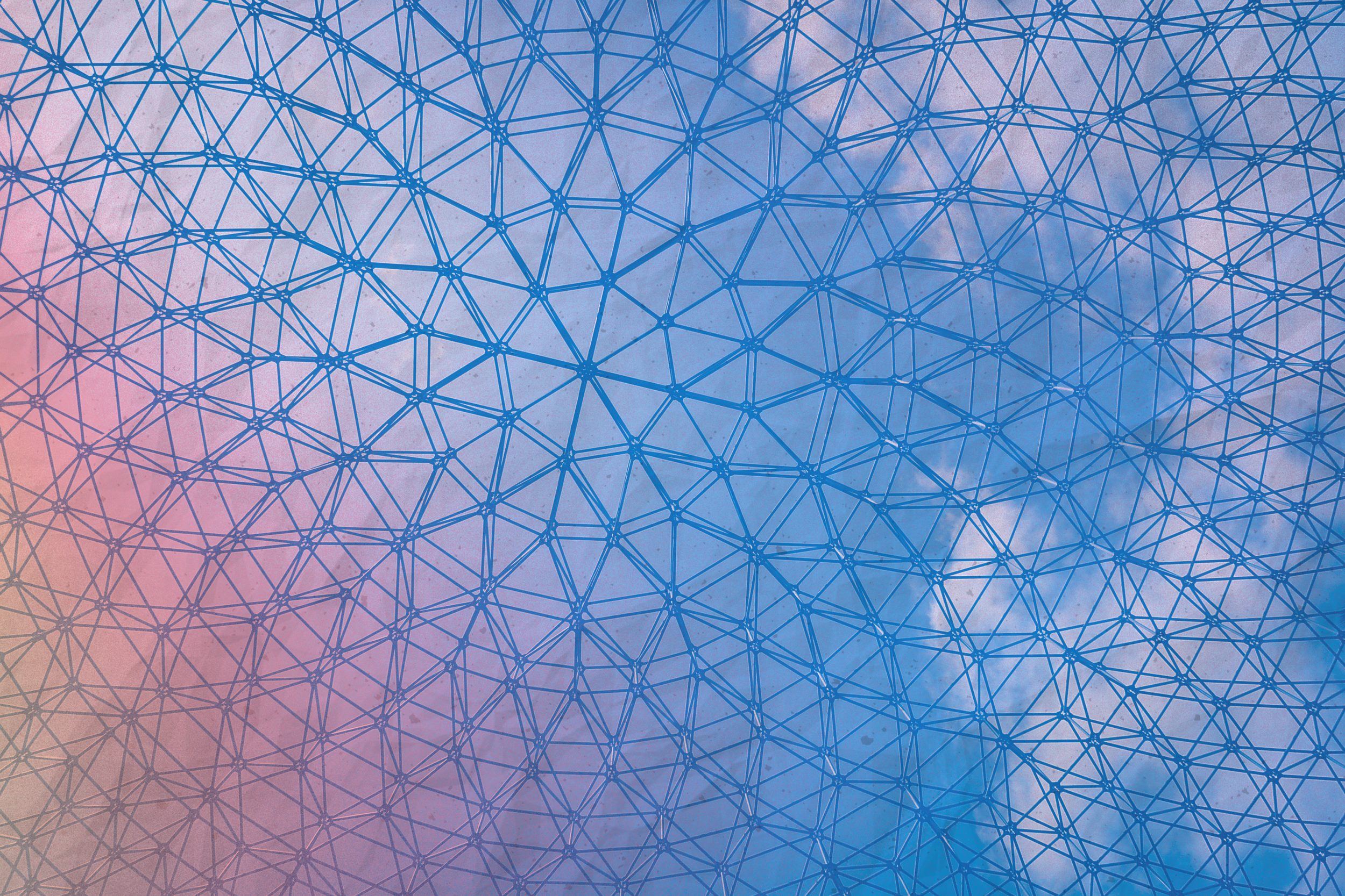 A geometric metal framework in front of a cloudy sky, with a gradient of pastel pink and blue colors.