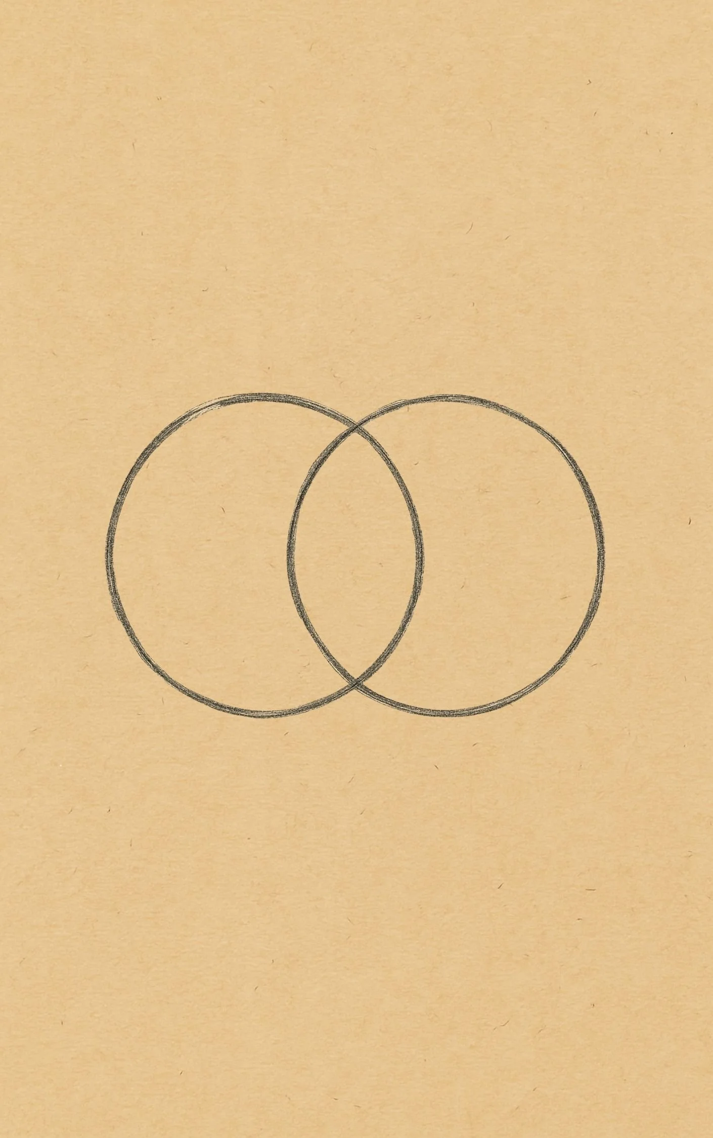 A hand-drawn outline of two overlapping circles on a piece of paper.