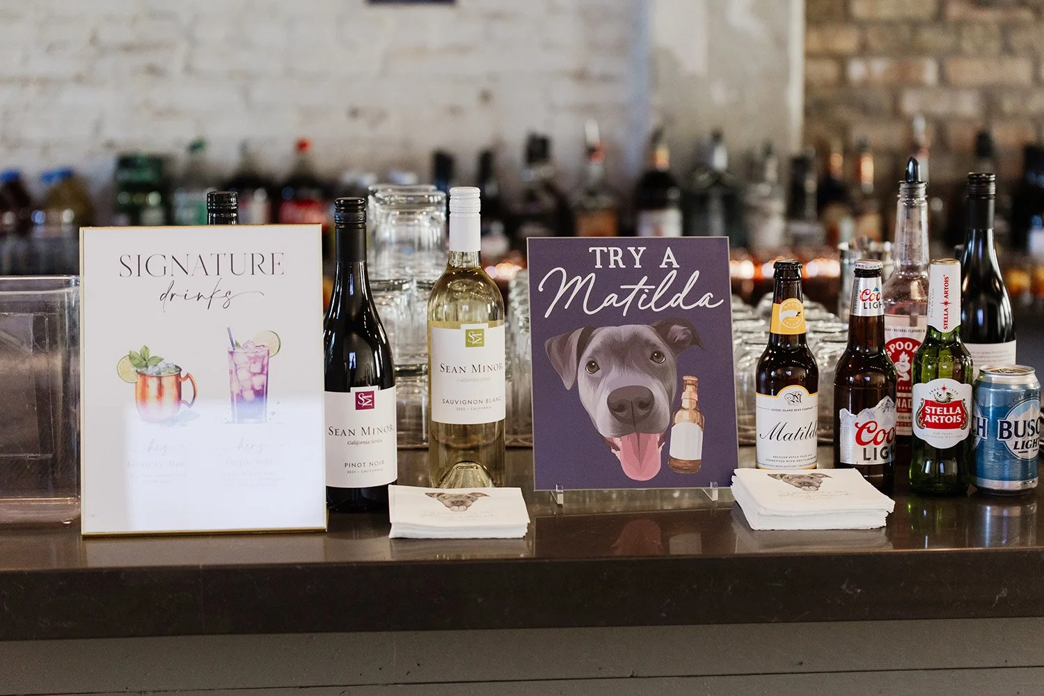 open bar with two custom drink signs and a custom painted dog sign