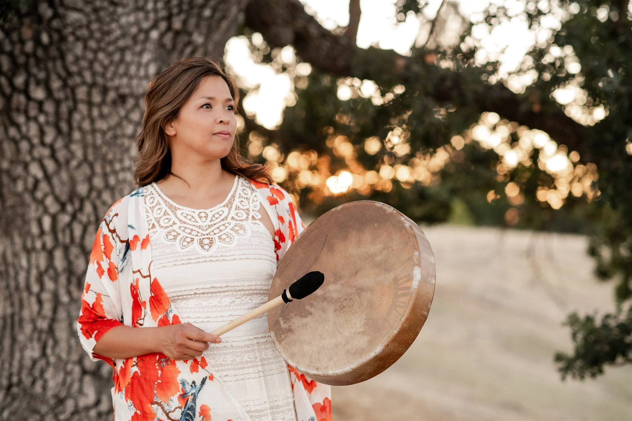 Acupuncturist Grace Killpack of Apo Acupuncture in Orinda, CA, playing a drum for spiritual healing.