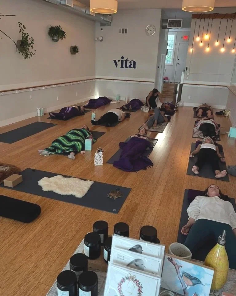 People lying on mats and blankets on the floor during a sound healing and acupuncture sessions in Lafayette, CA.