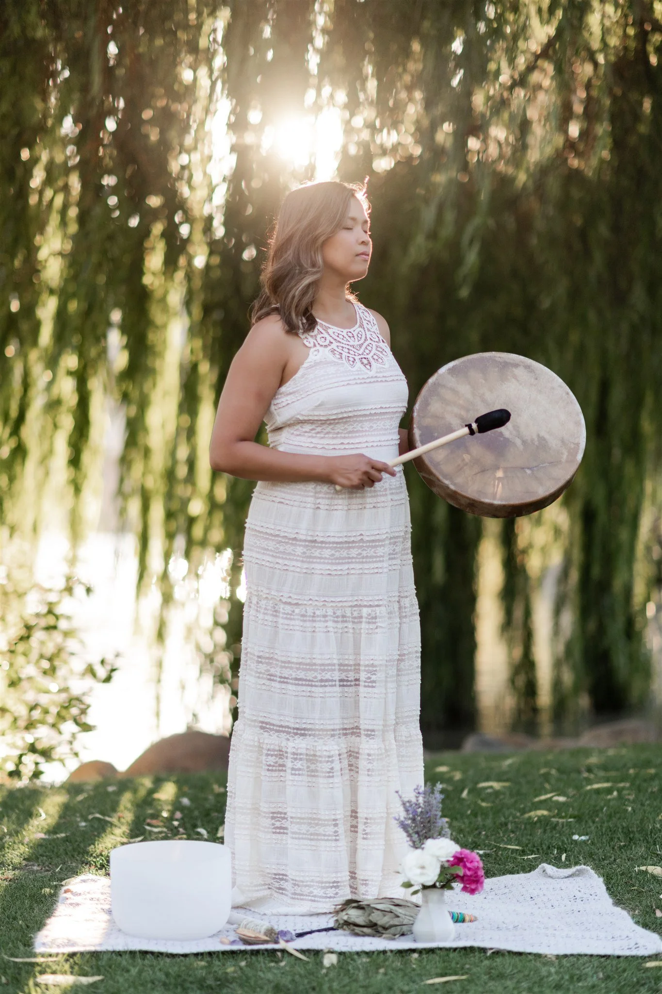 Acupuncturist Grace Killpack of Apo Acupuncture in Orinda, CA, playing a drum for spiritual healing.