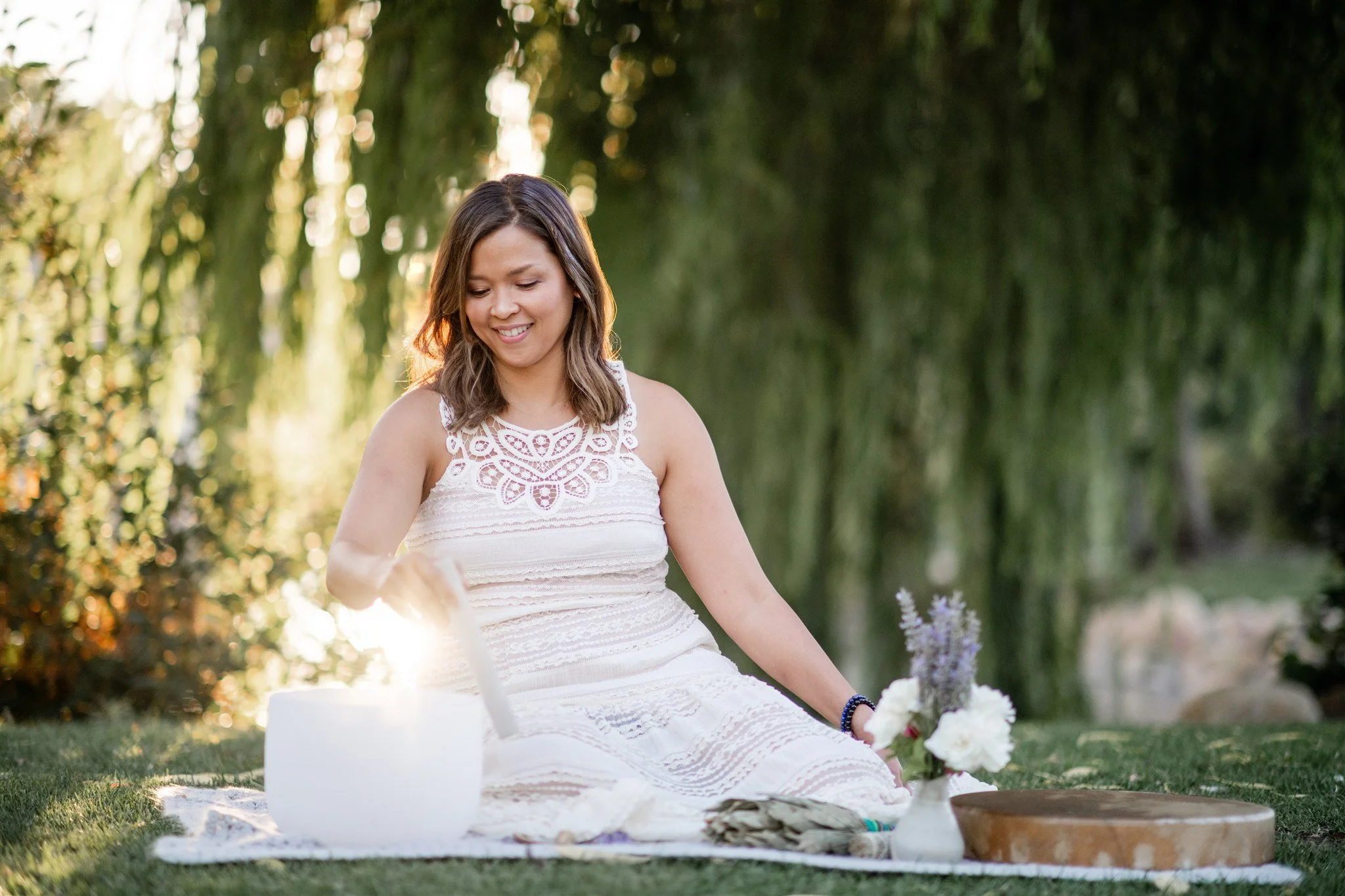 Grace Killpack of Apo Acupuncture playing sound bowls outside for a meditation session in Lafayette, CA.
