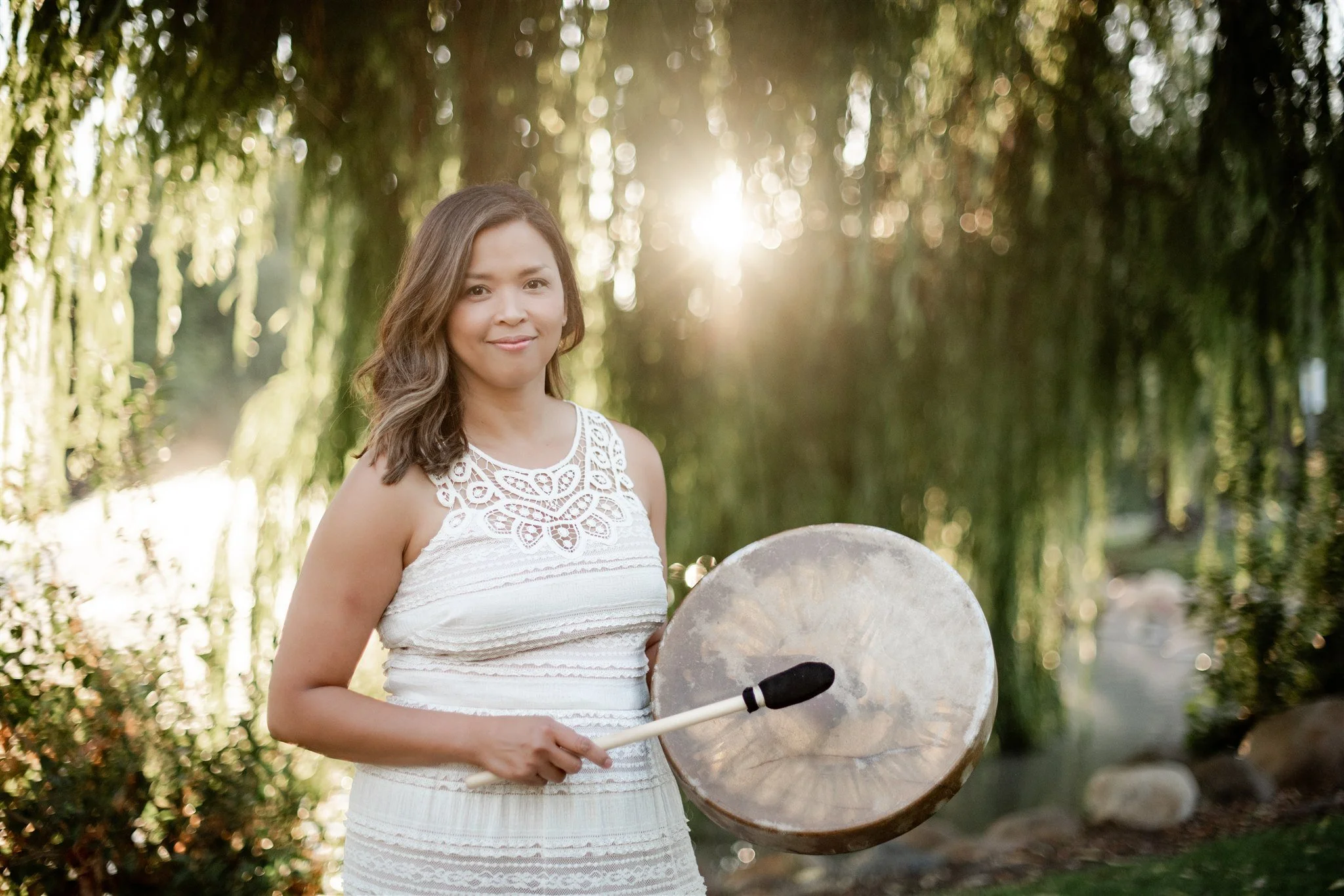 Acupuncturist Grace Killpack of Apo Acupuncture in Orinda, CA, playing a drum for spiritual healing.