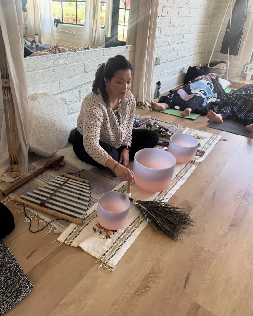 Grace Killpack playing sound bowls during a sound healing and acupuncture sessions in Lafayette, CA.