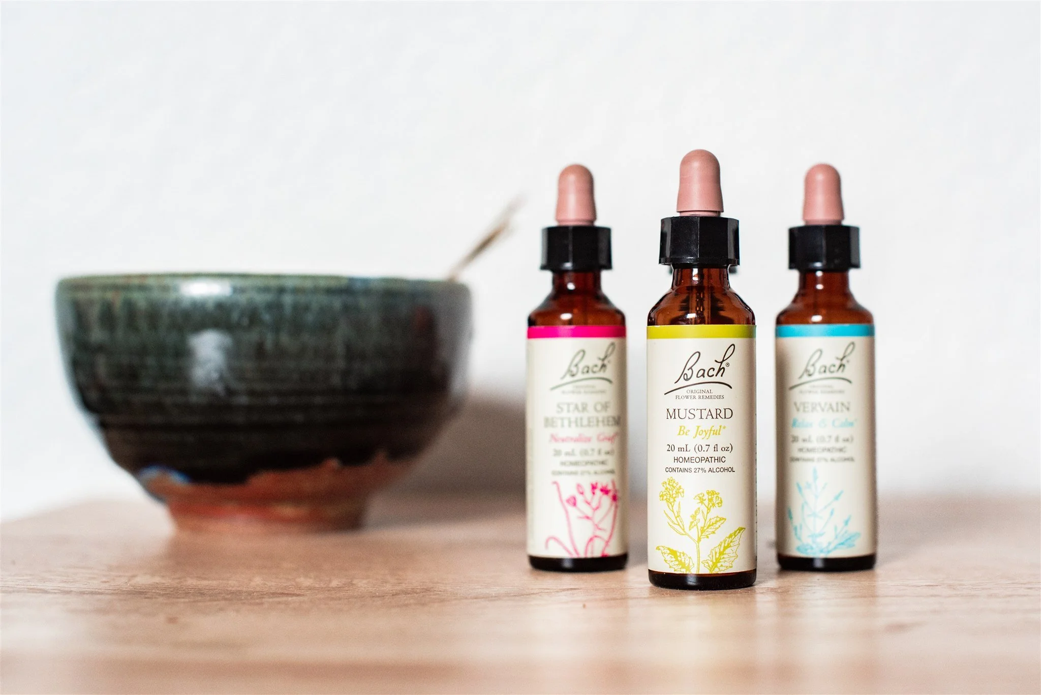 Three bottles of essential oil and a ceramic bowl used in Chinese Medicine at Apo Acupuncture in Orinda, CA. 