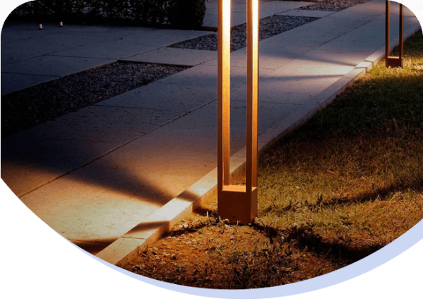 Outdoor sidewalk illuminated by pathway lights at dusk