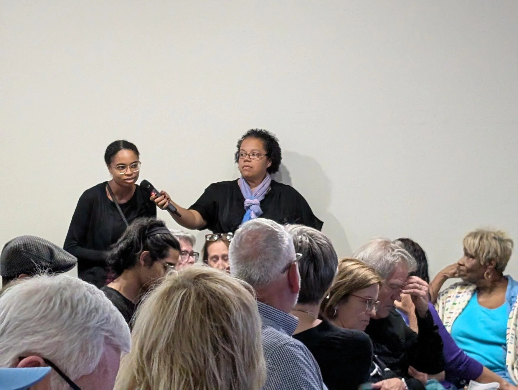 Jessica Nichols holding a microphone for a student