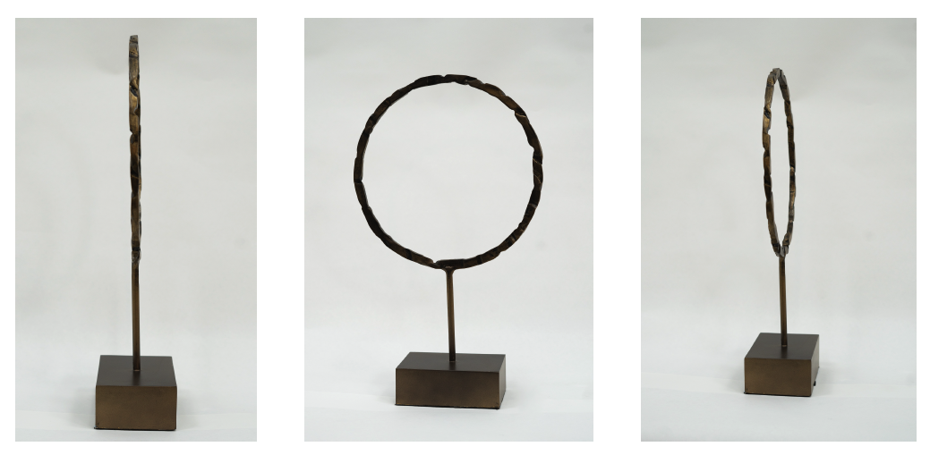Sculpture of a circular ring mounted on a stand, viewed from front and side angles.