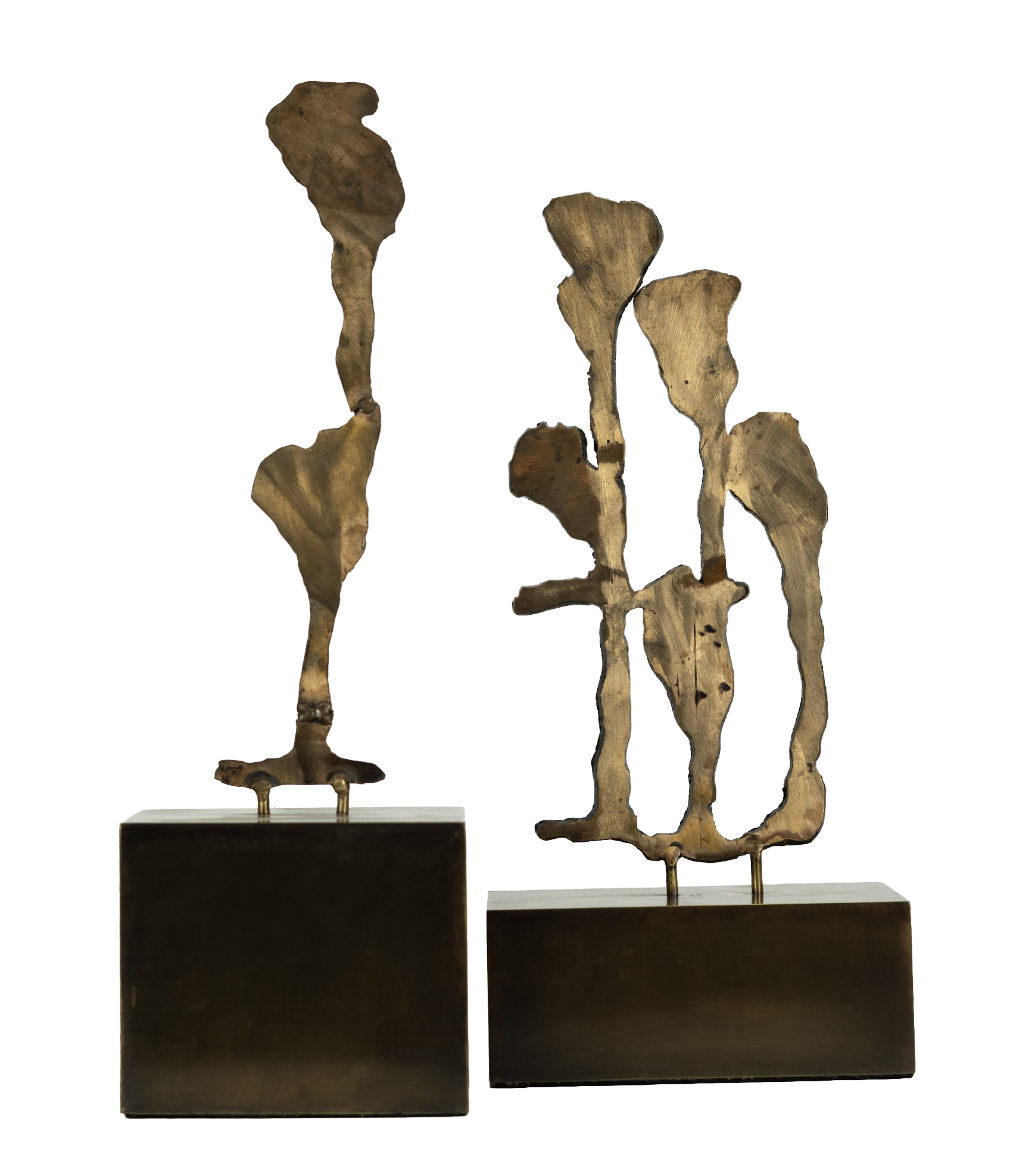 Close-up photo of two modern art sculptures resembling stylized birds, mounted on black rectangular bases, with a background of colorful blurry lights.