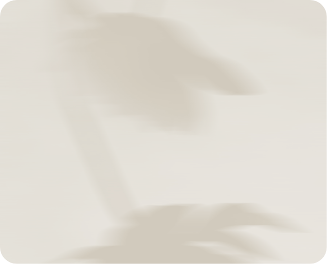 Blurred silhouette of a bird, possibly a crane or heron, standing beside water.