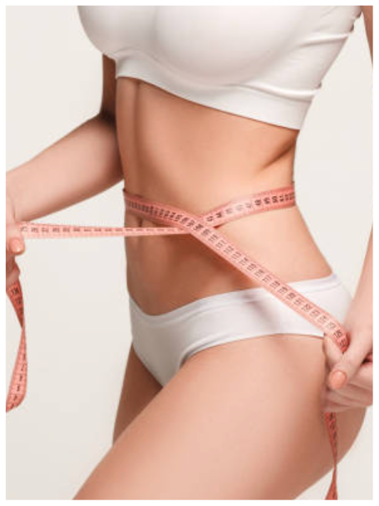Woman in white sportswear measuring her waist with a pink measuring tape.