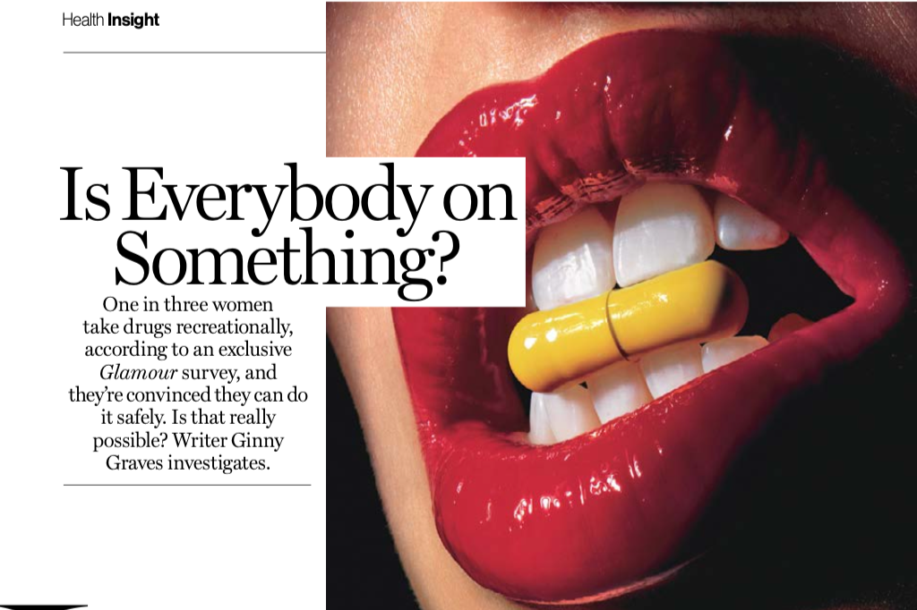 Close up of a mouth with red lipstick biting a yellow pill.
