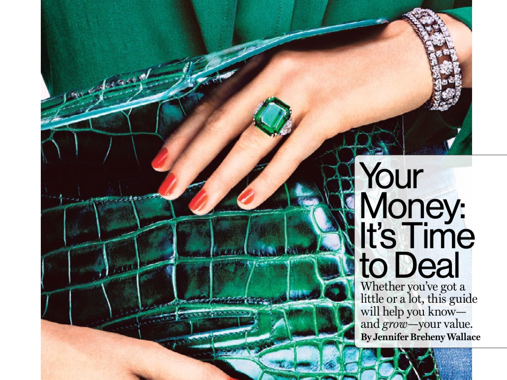 Hands holding a green snakeskin purse.