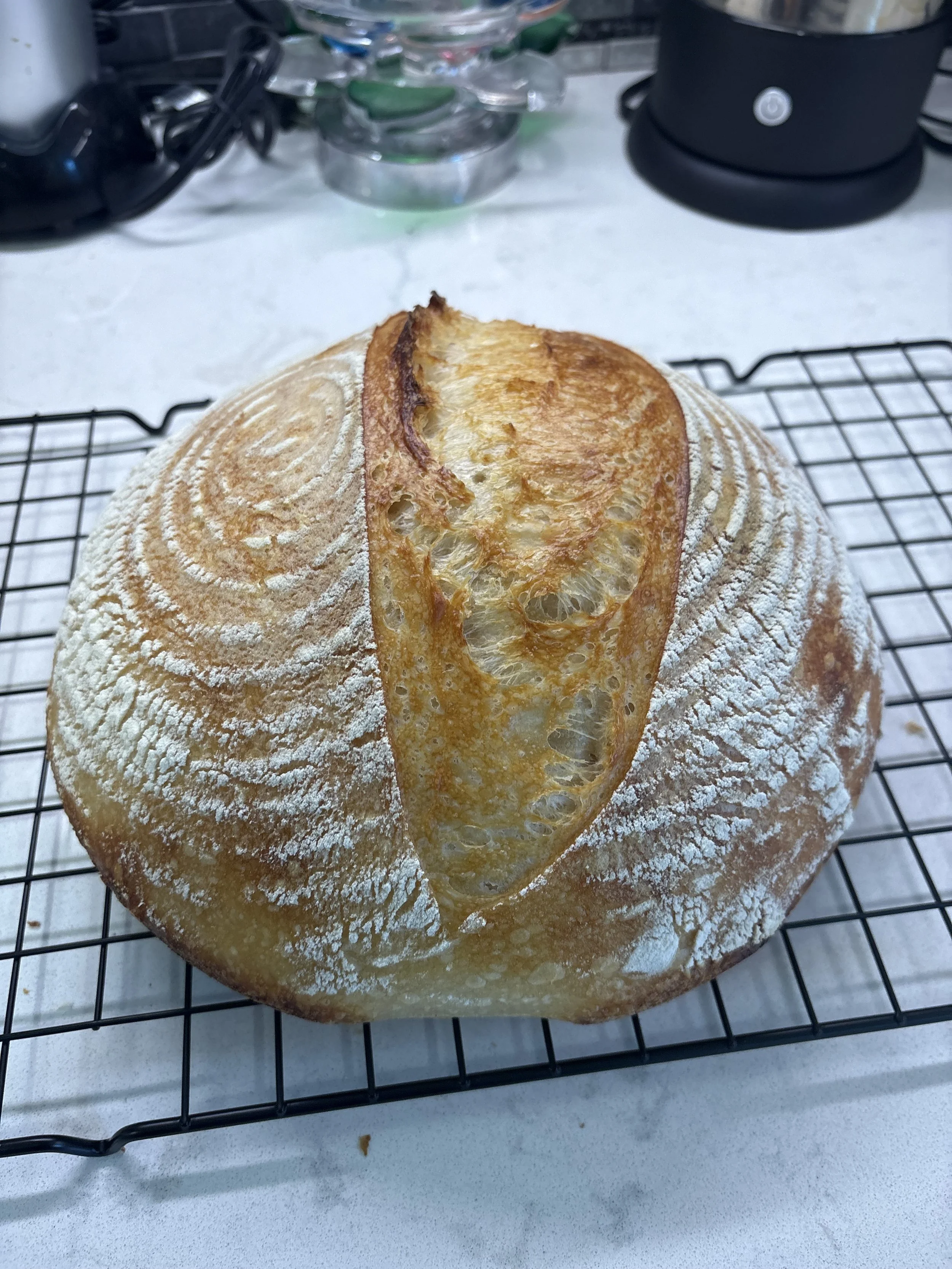 Sourdough bread on a cooling rack, symbolizing the slow and intentional process of healing and life transitions.