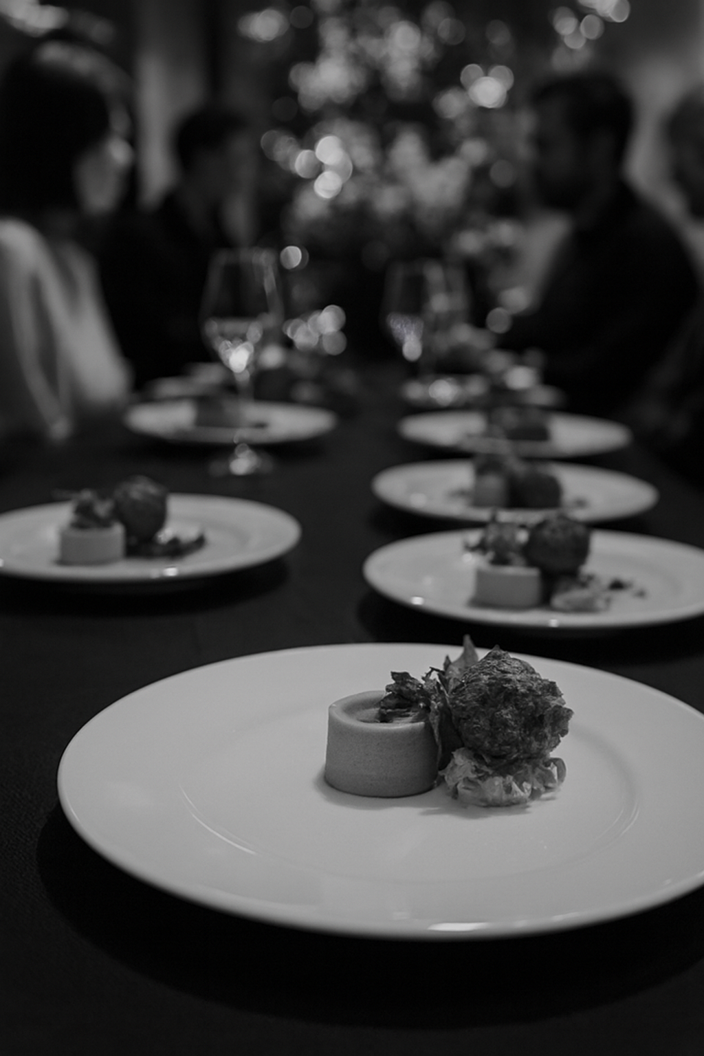 Pea and truffle mousse paired with Dorset crab salad, crab beignet, micro coriander, red pepper coulis, and caviar. Presented for a formal dinner, this refined JustInc. private chef creation is enjoyed across South of England.