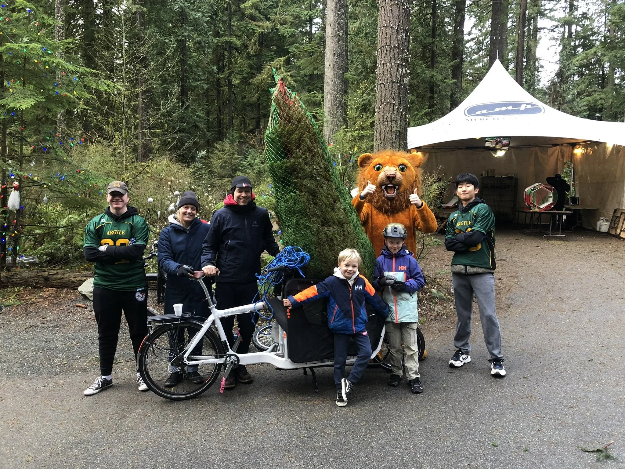 Lion Pipers kids on bike with tree at lot.JPEG