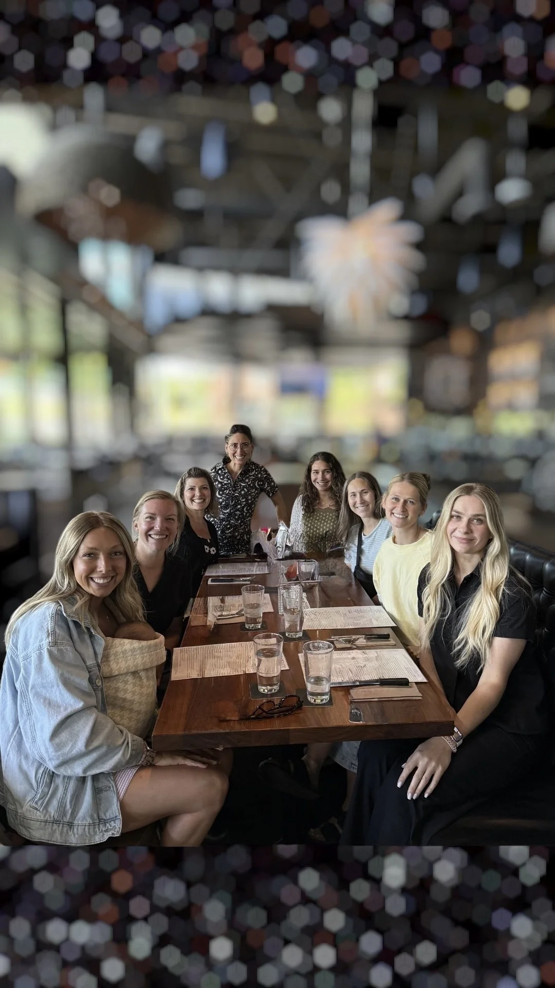 The staff of Samish Bay Dental, sitting at a restaurant table, smiling for the camera and looking friendly and welcoming. Includes the dental hygienists and Dr. Jessica Dubek, the dentist.