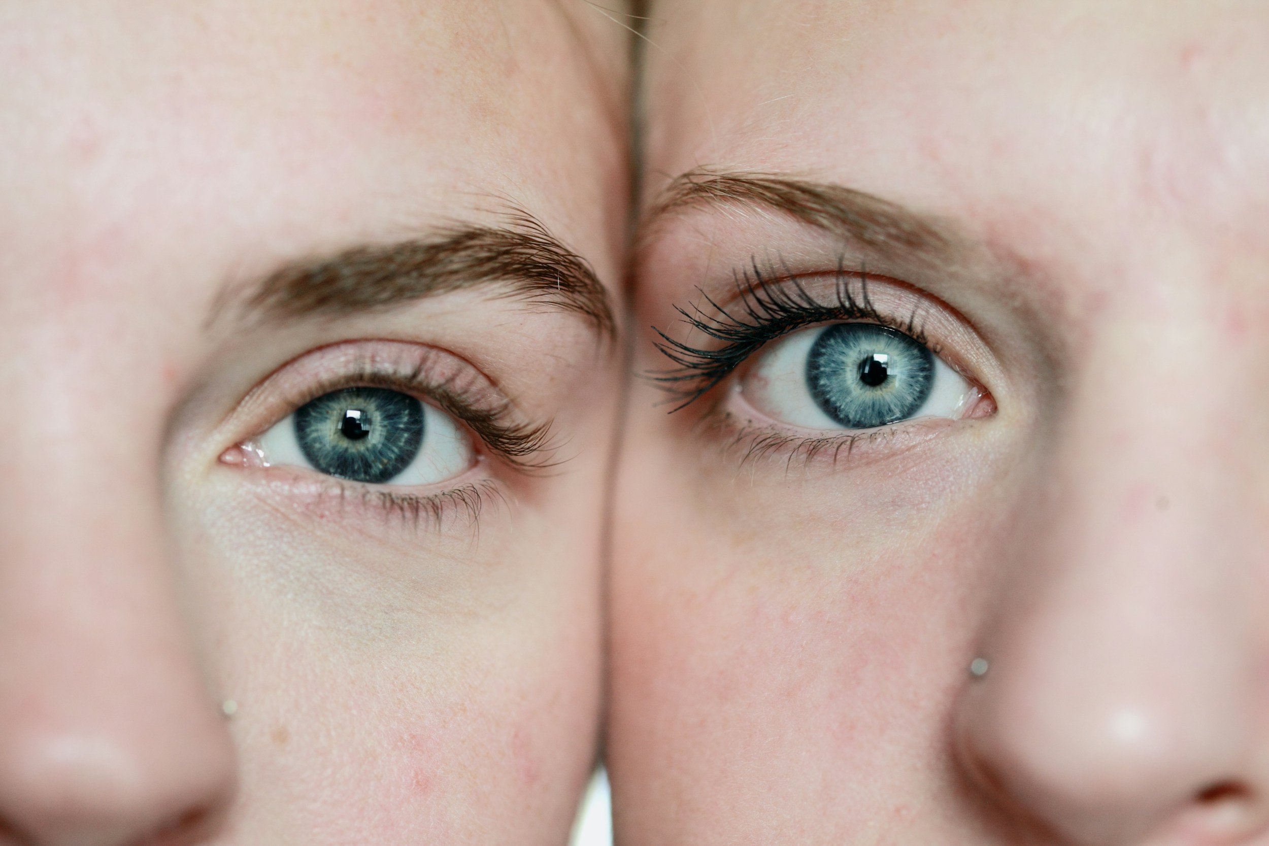 Close-up of two people with similar blue eyes side by side