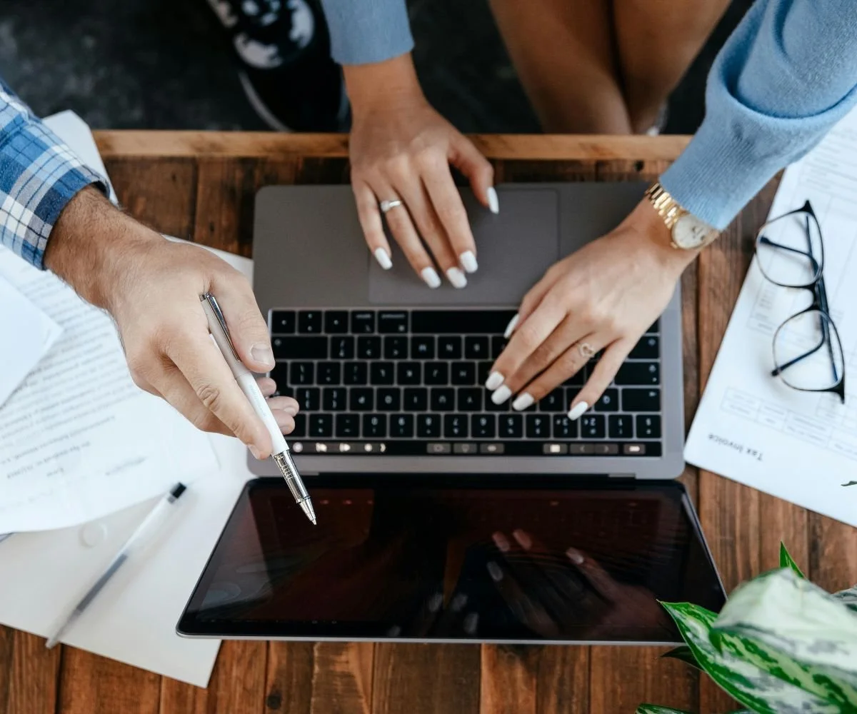 Nonprofit staff collaborating on grant writing during a strategy session with a remote grant consultant.