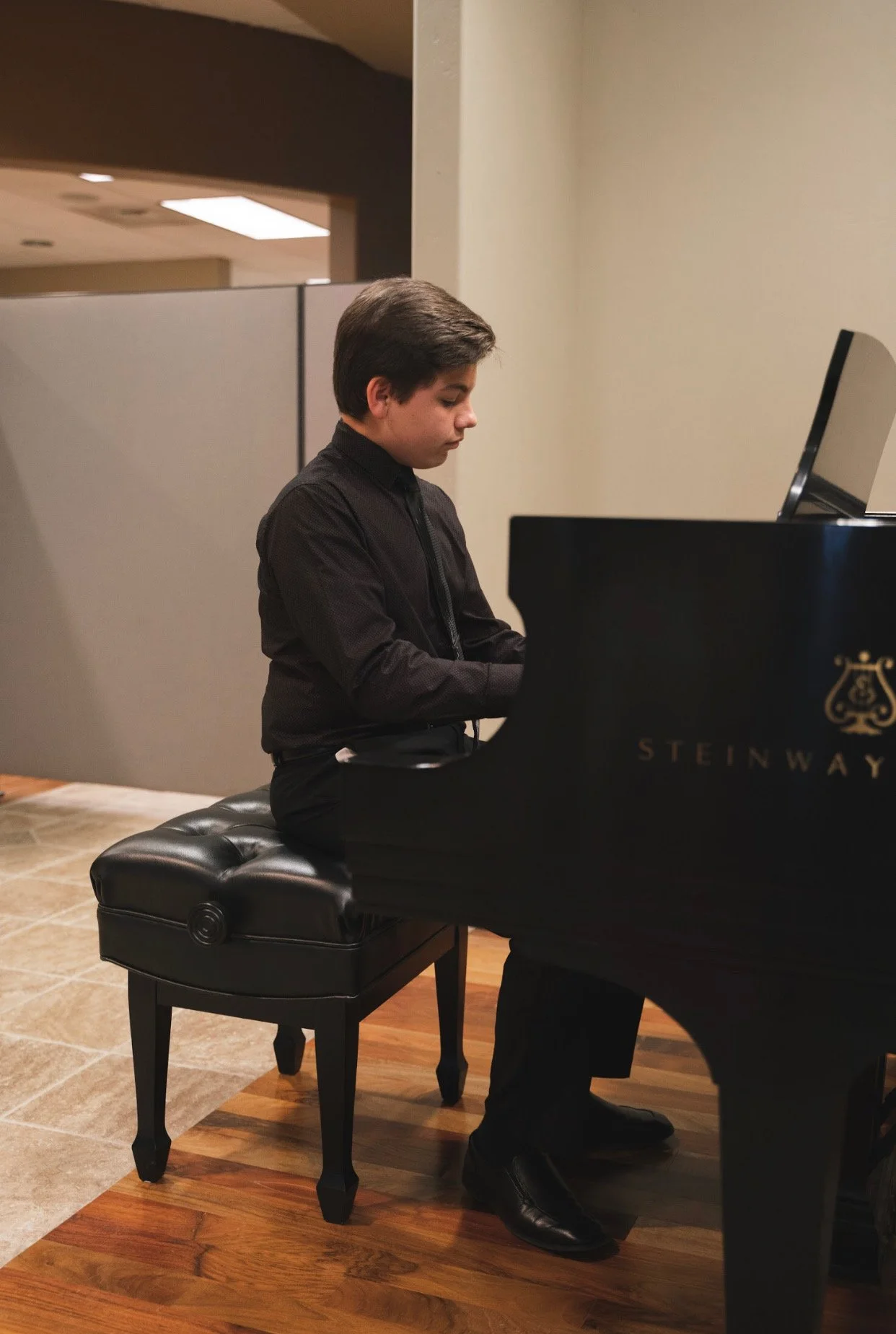 Young pianist receiving applause on stage