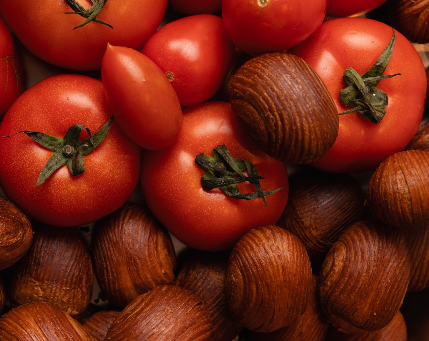 Fresh tomatoes and eggies — seasonal ingredients from Social Goods' August menu.