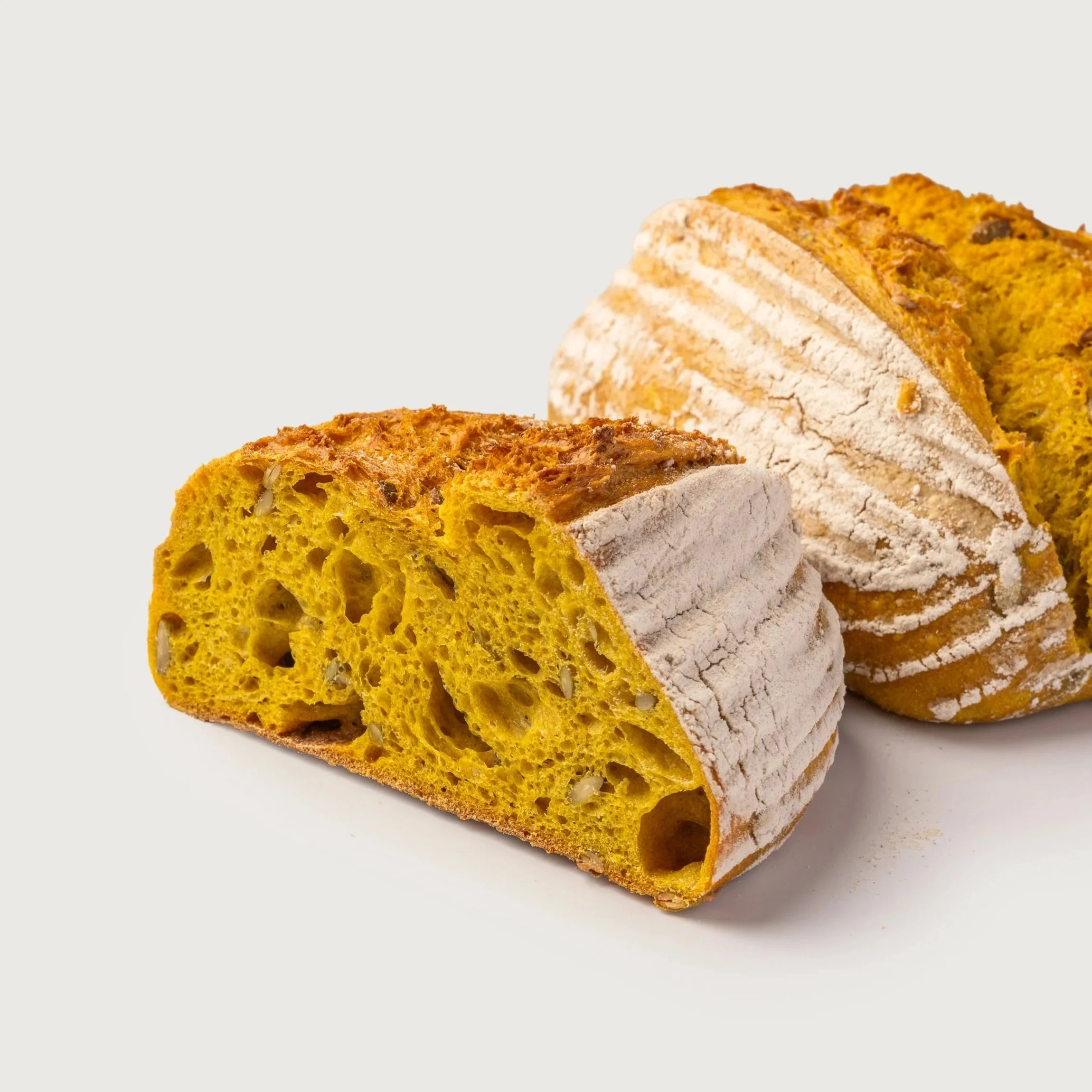 Classic Sourdough sliced to show airy crumb and golden crust — Social Goods Modern Bakery.