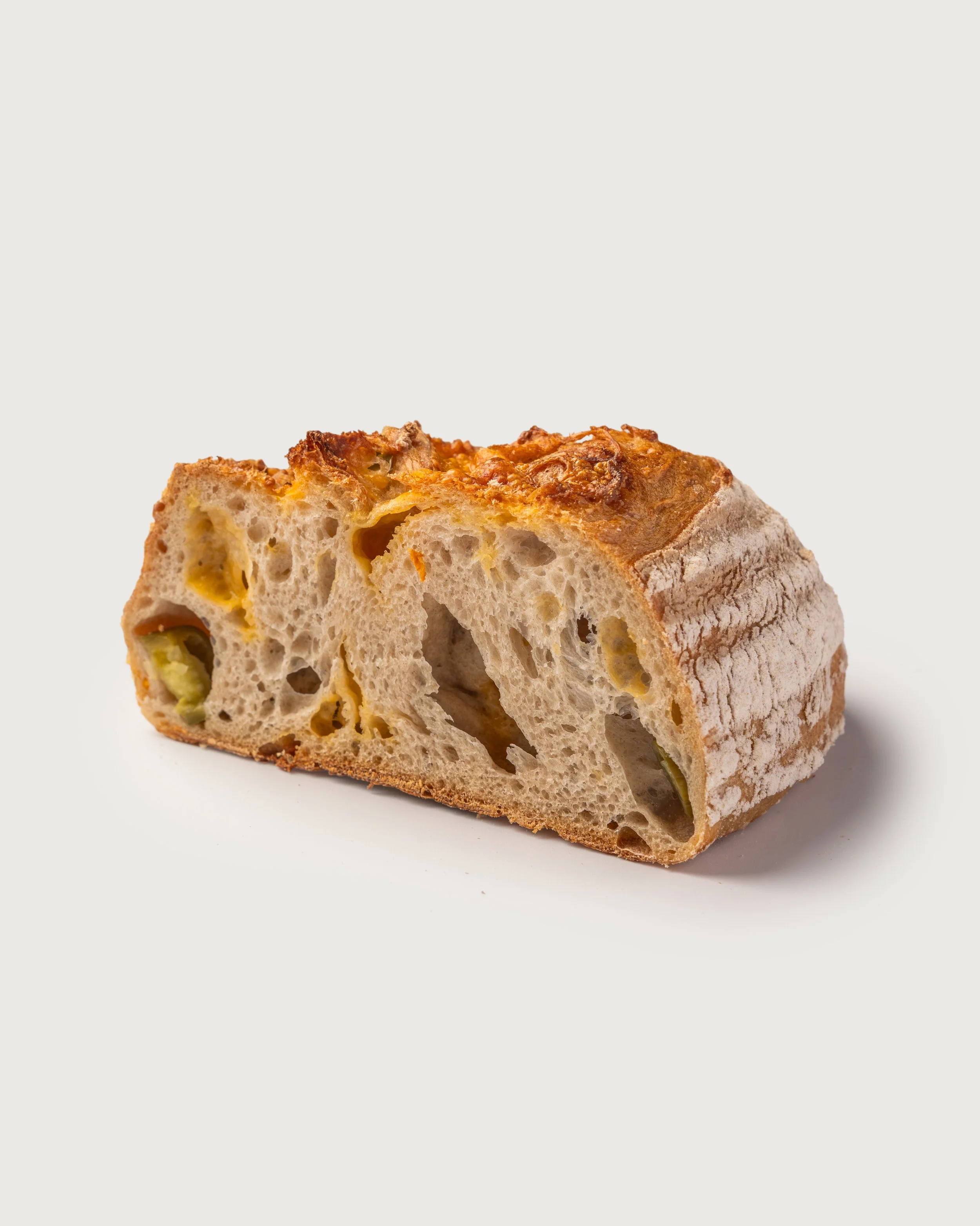 Walnut Raisins Sourdough loaf sliced to show crusty crust and soft, nutty interior — Social Goods Modern Bakery.