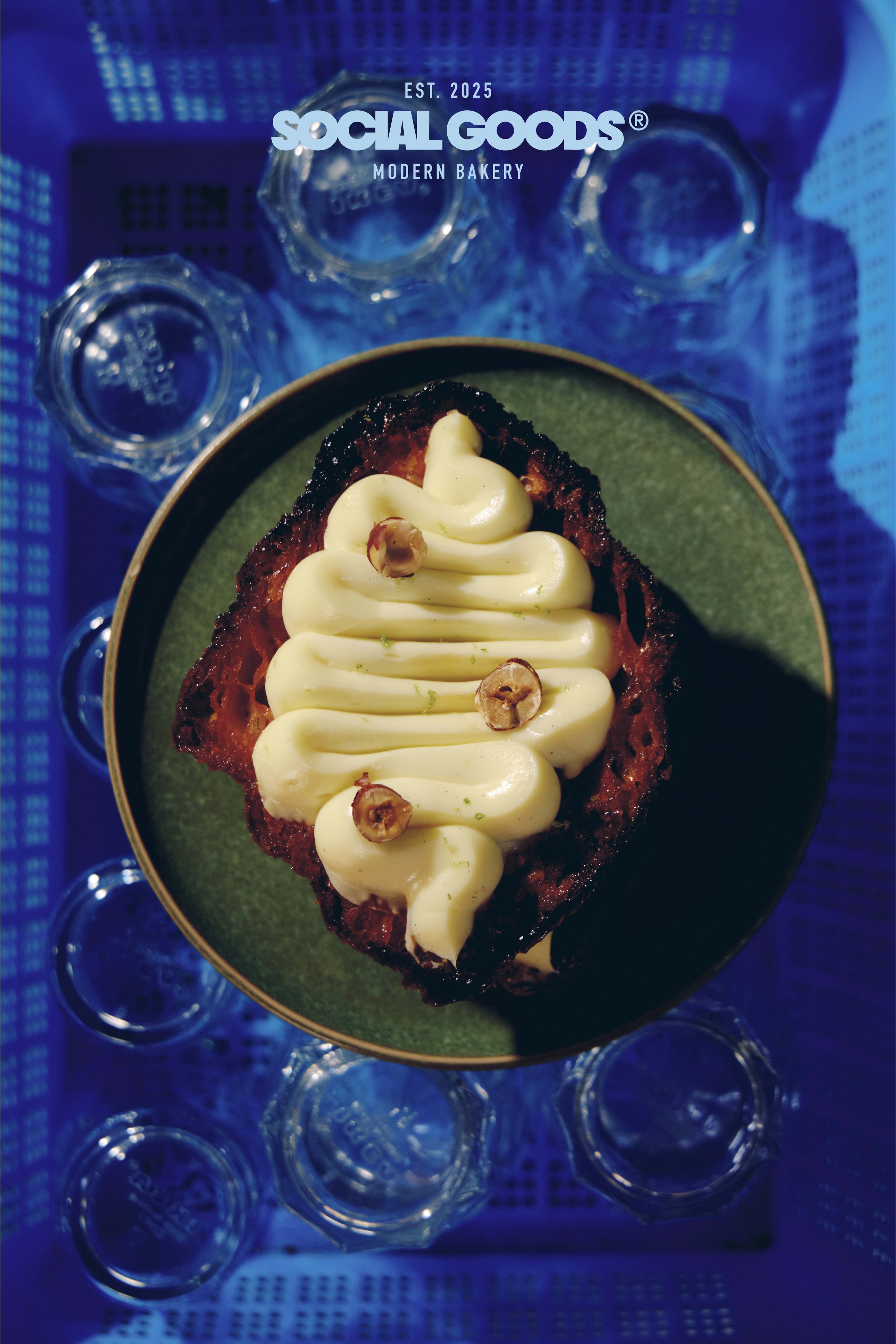 A plated Mille-Feuille croissant with a hazelnut-topped creamy filling, styled on a green plate
