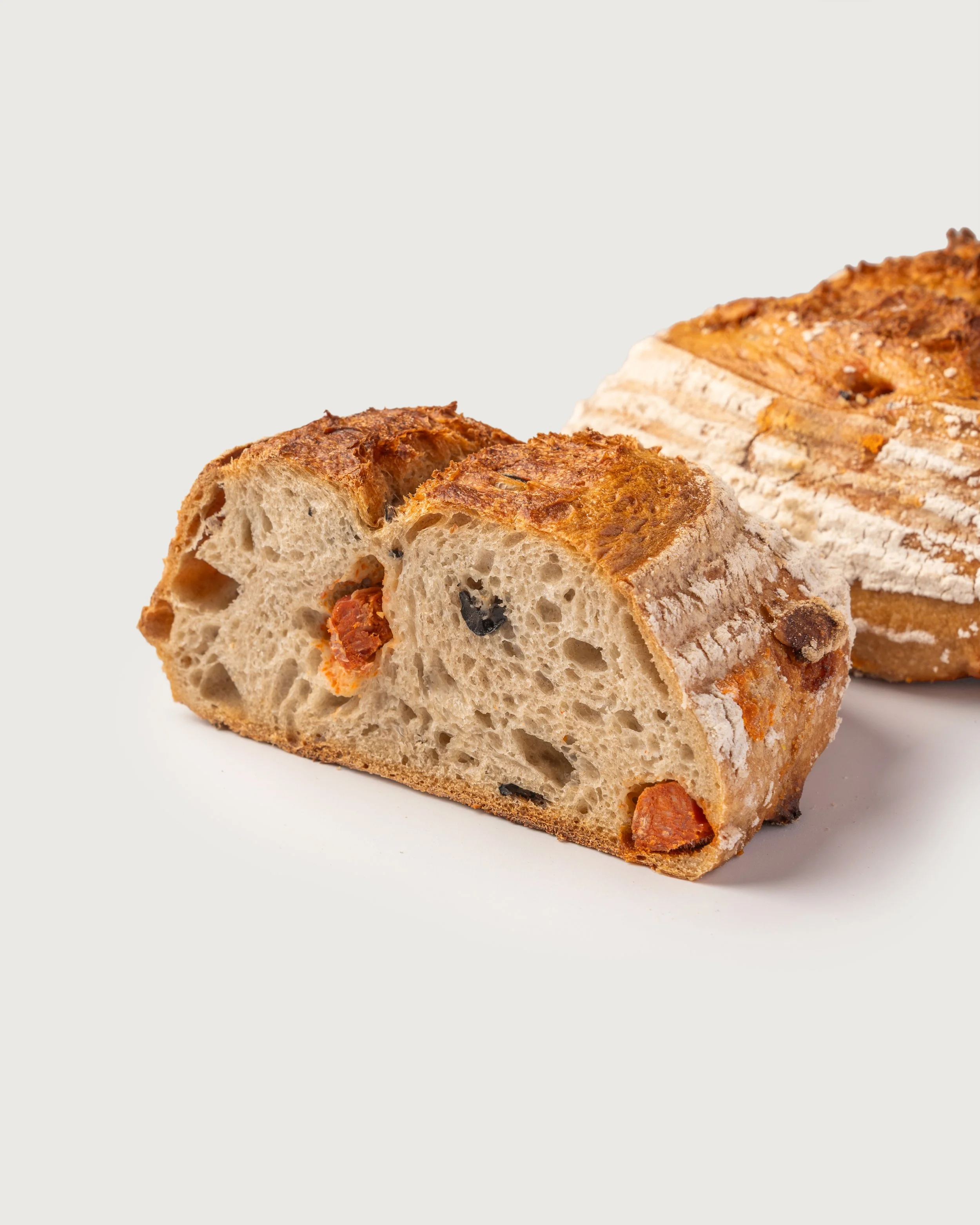 Turmeric & Pumpkin Seeds Sourdough — golden ancient grain loaf studded with pumpkin seeds, Social Goods Modern Bakery.