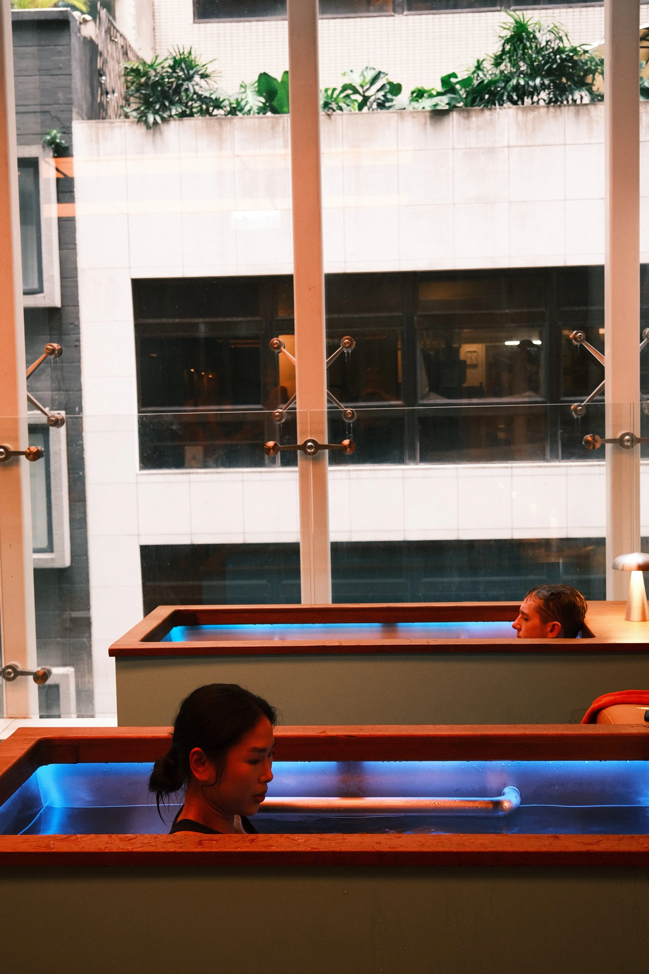 Guests dining at Social Goods Modern Bakery Central with the Pottinger Street greenery visible through the windows.