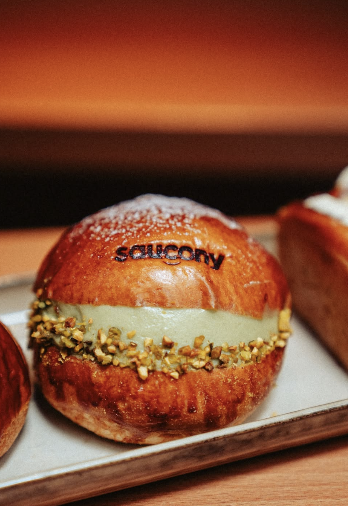 Branded edible-print maritozzi created for a Saucony activation at Social Goods Modern Bakery Central.