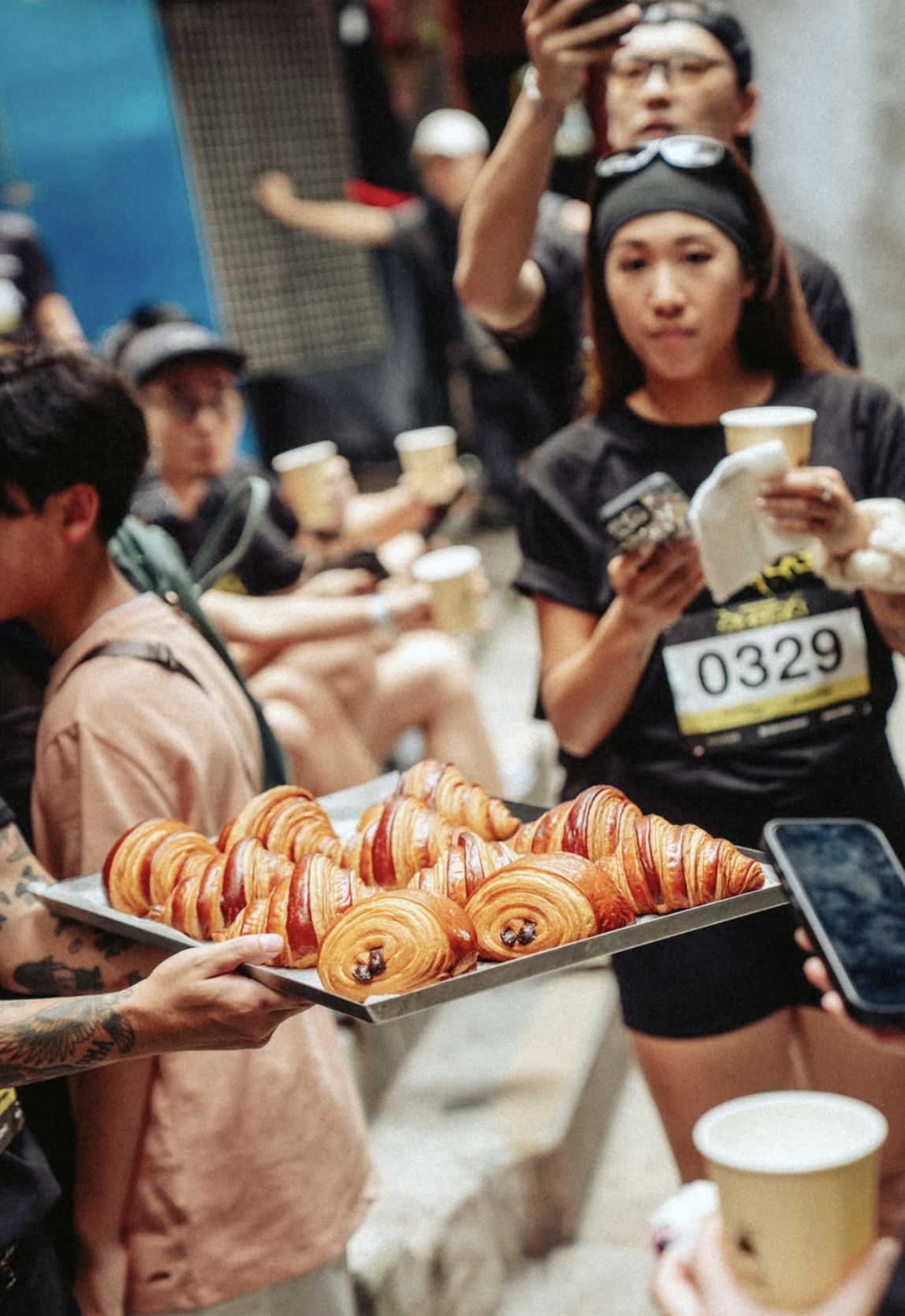 Hong Kong run club members refuelling with Social Goods croissants at a post-race break station.