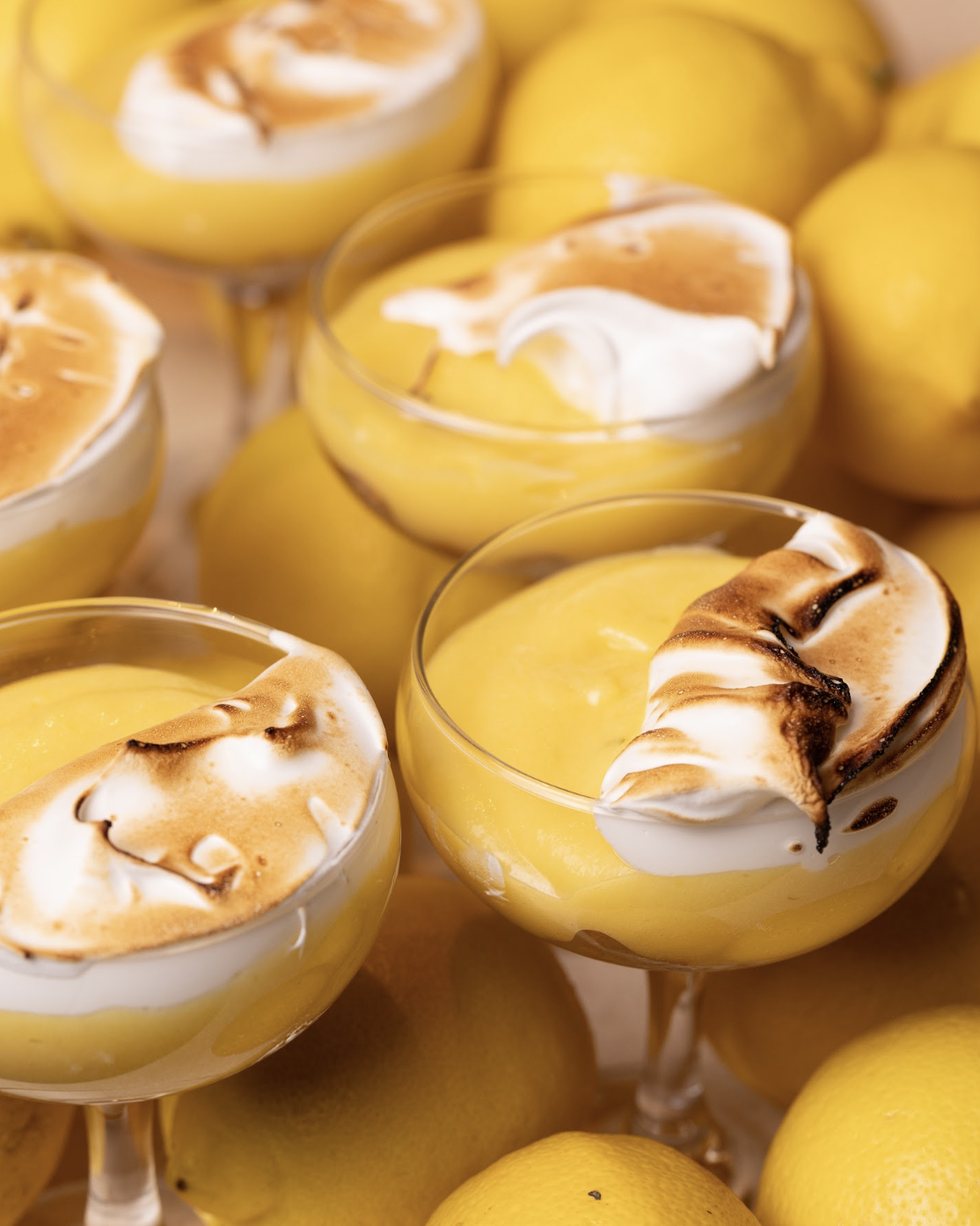 Lemon cheesecake with toasted meringue in glass bowls — August special at Social Goods, Central.