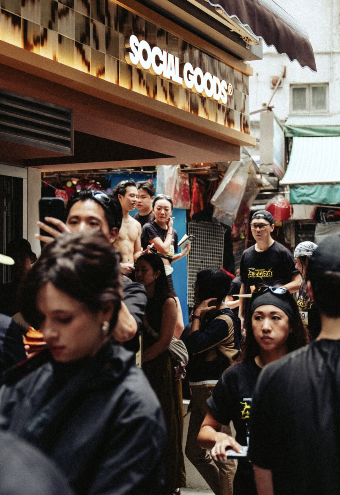 Crowd outside Social Goods Modern Bakery on Pottinger Street, Central Hong Kong, under the burnt-orange awning.