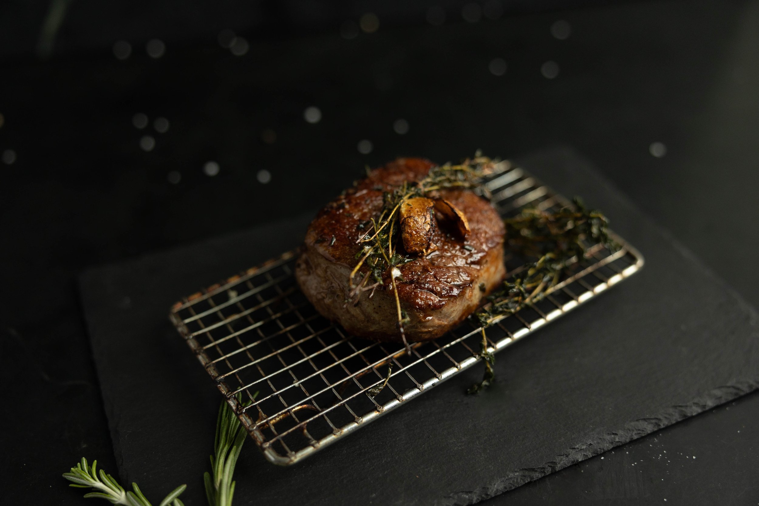 Cooked Manzo Fassone tenderloin garnish on beautiful slate board