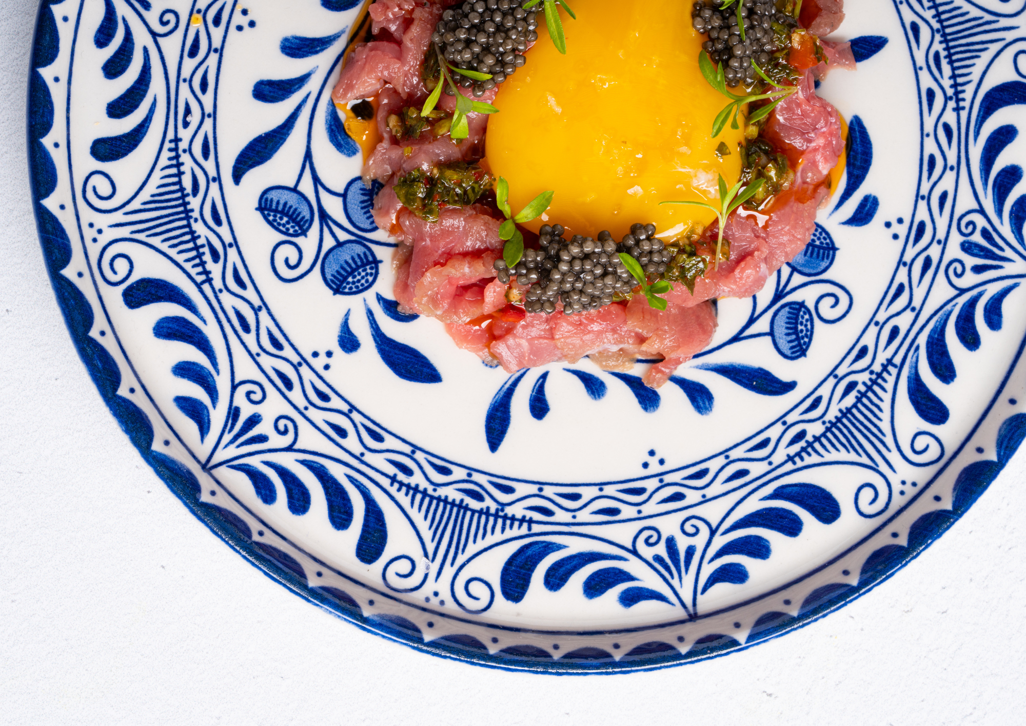 Manzo Tartare on blue and white dish