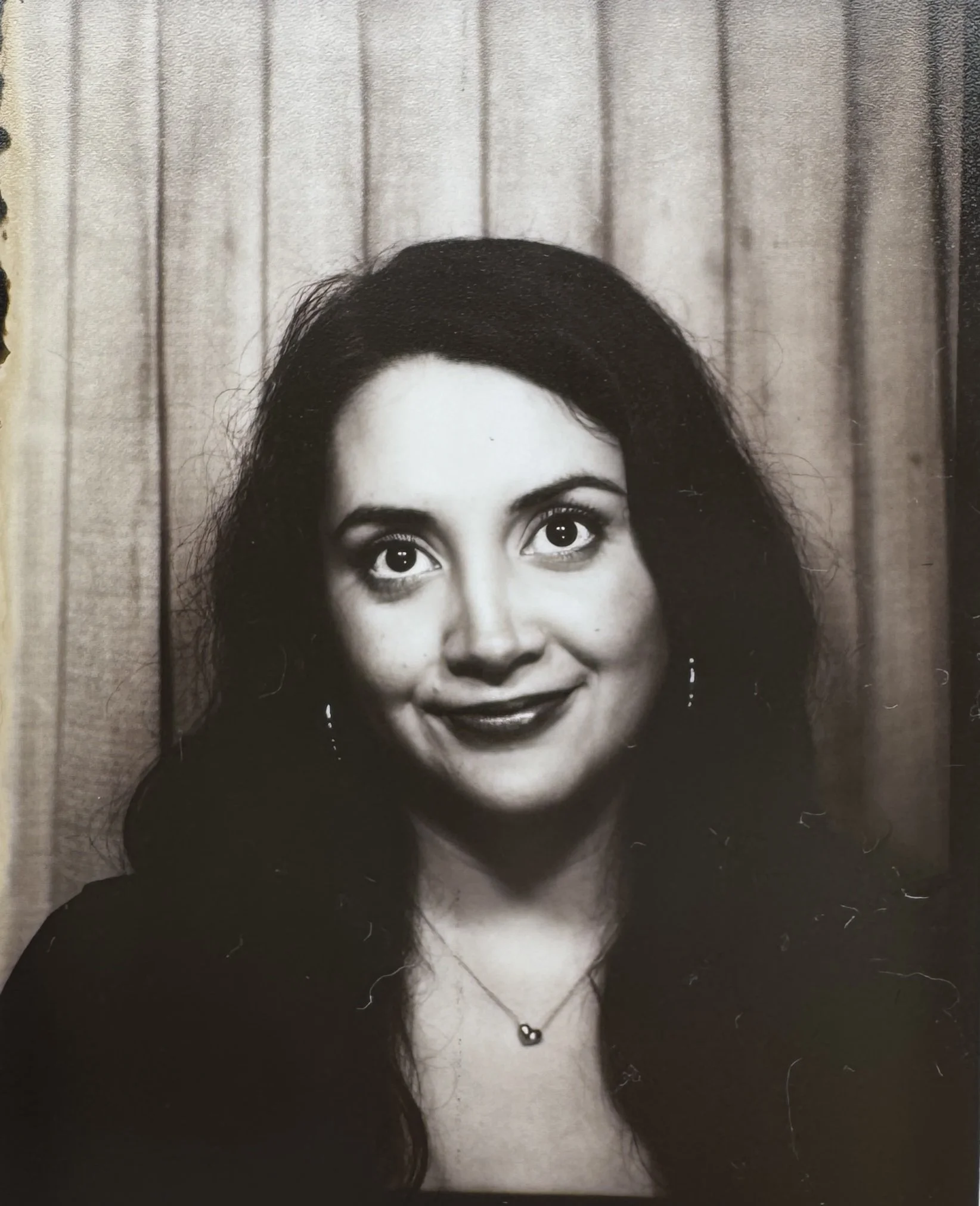 A black-and-white photobooth headshot of Naomy Pedroza