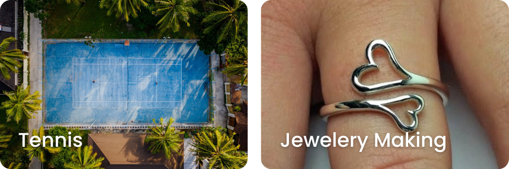Top-down view of a blue tennis court surrounded by green trees and buildings on a sunny day. Close-up of a silver ring with two heart shapes on a person's finger.