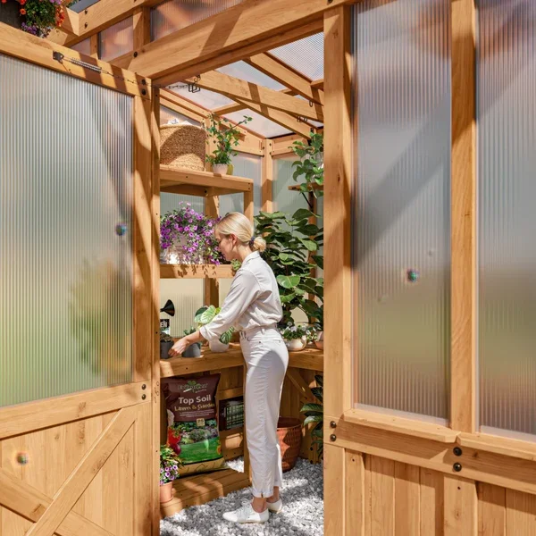 SIZE_9x6_PoppyGreenhouse_Lifestyle_WomanGardening_V1.webp