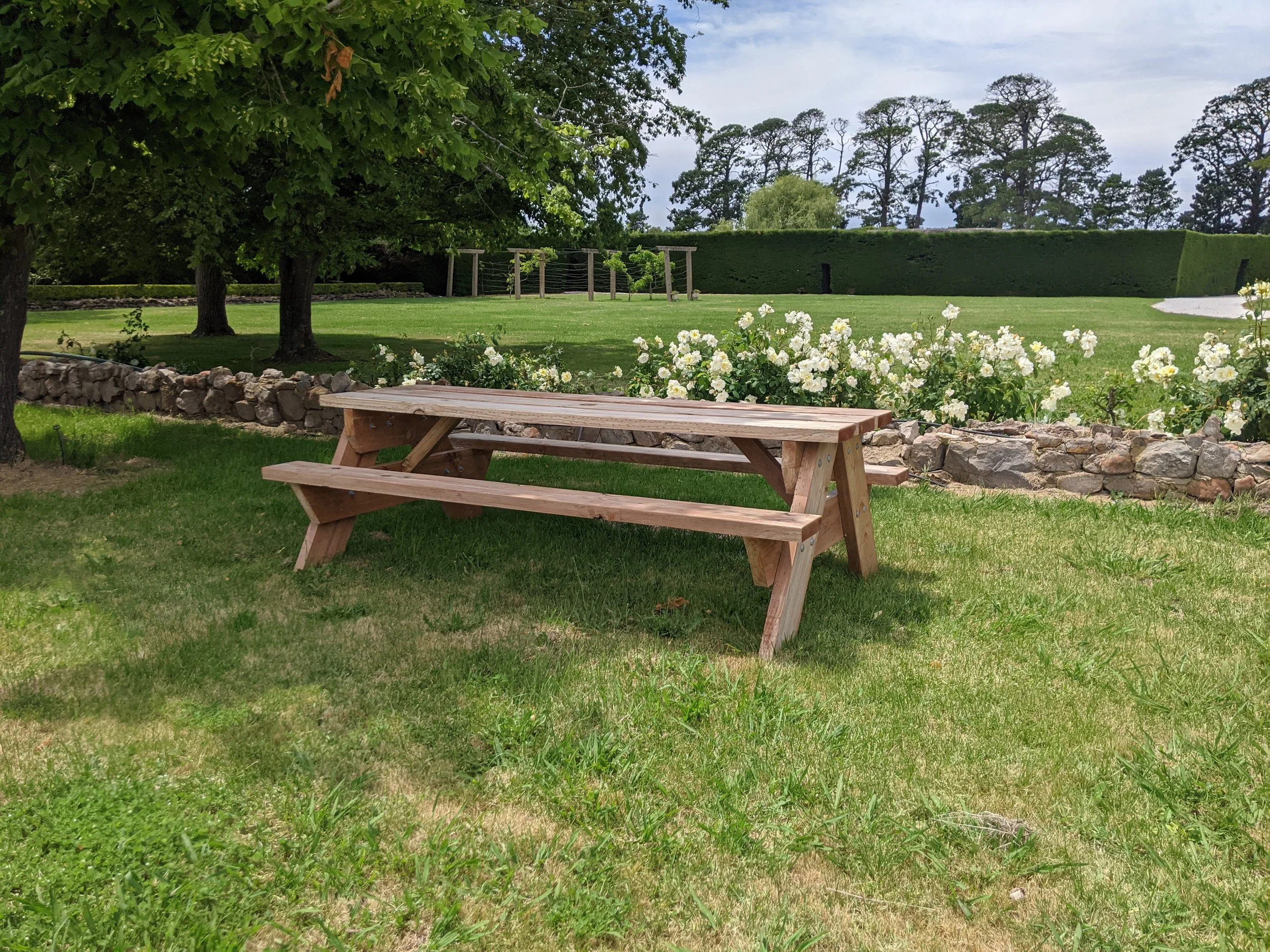 Eight seater outdoor picnic tables in a garden