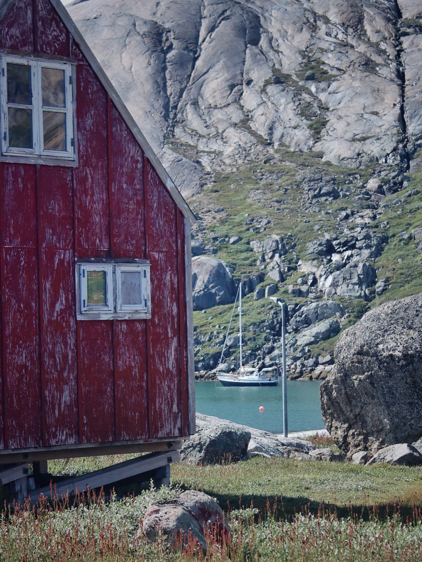 Aappilattoq &ndash; &ldquo;the red one&rdquo; 

Arrived yesterday in rain, mist, and low clouds&hellip; woke up this morning to towering 1,300-metre peaks and the stunning setting of this tiny settlement at the entrance of Prince Christian Sund. Our 