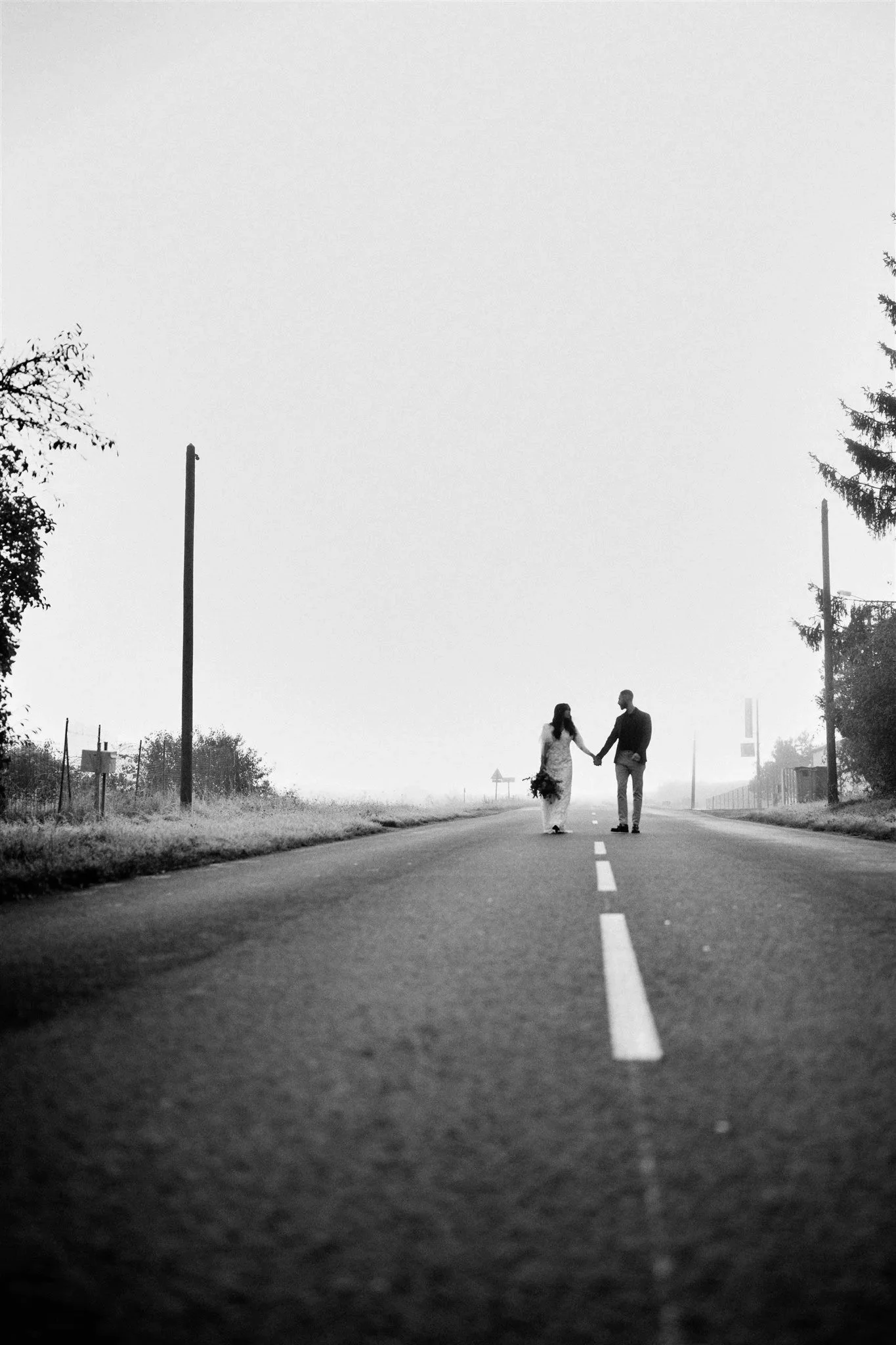 Couple de mariés marchant sur une route de campagne - approche slow wedding Minute Papillon