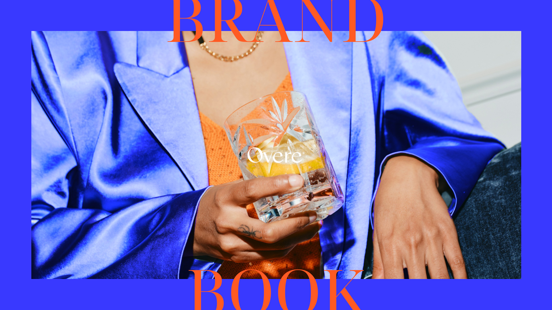 Person wearing a shiny blue jacket holding a glass of water with lemon slices, with the words 'BRAND' and 'BOOK' overlayed on the image.